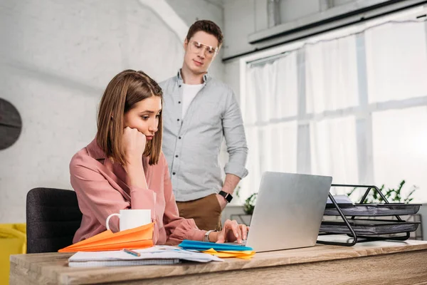 Depressed couple reading on Tablet