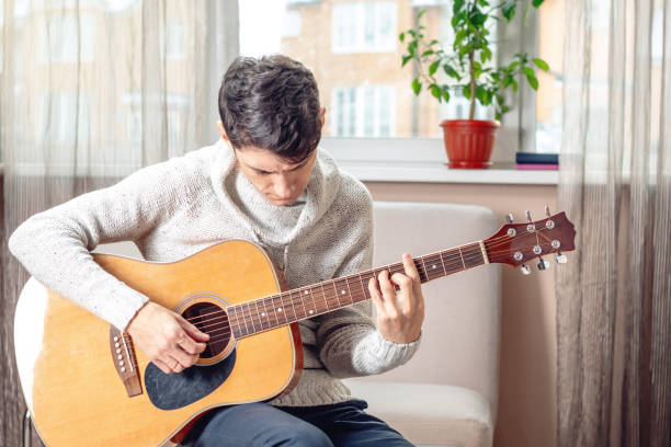 Young man playing acoustic guitar